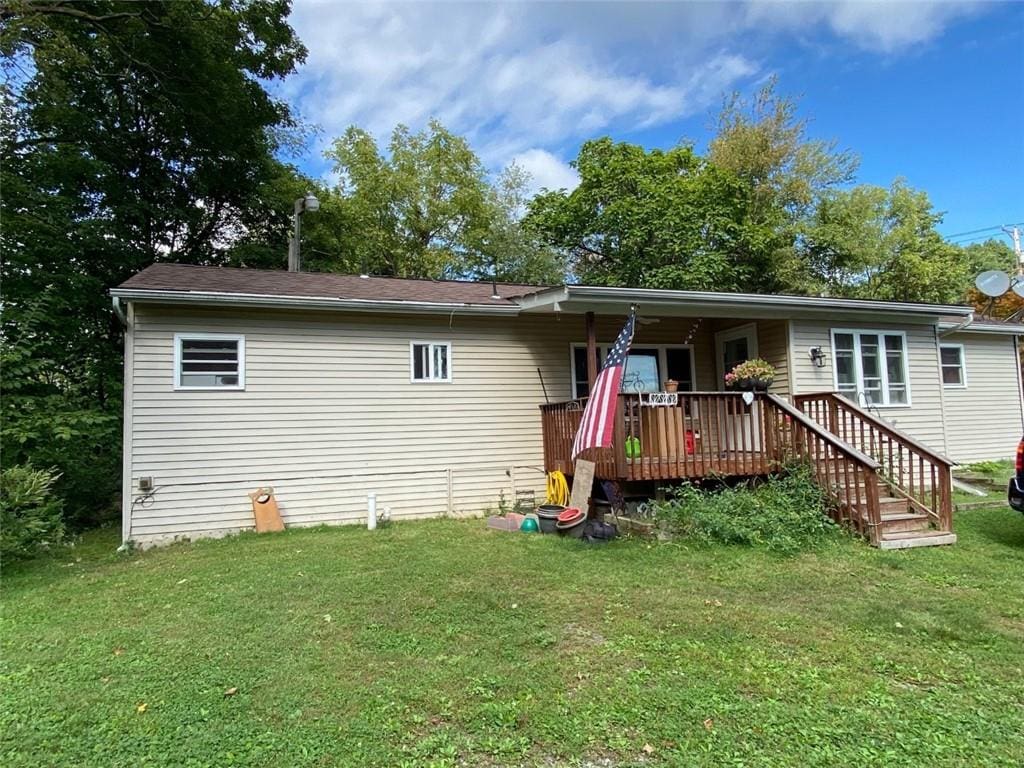 back of house featuring a yard and a deck