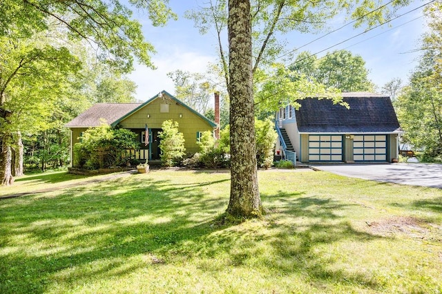 view of front of home with an outbuilding and a front lawn