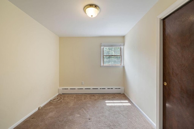 carpeted spare room with baseboard heating