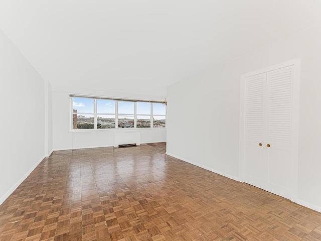 unfurnished living room with dark parquet floors