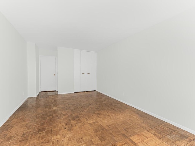 unfurnished room featuring parquet flooring