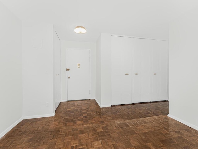 hallway with dark parquet flooring