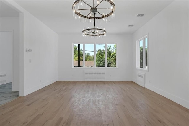 3 Forshee St, Monroe, NY 10950 - unfurnished room featuring radiator, a chandelier, and wood finished floors