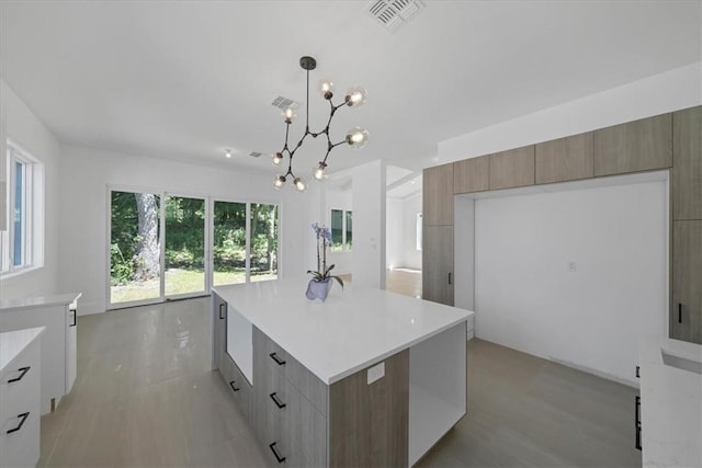 3 Forshee St, Monroe, NY 10950 - kitchen with modern cabinets, a chandelier, light countertops, light wood-type flooring, and pendant lighting