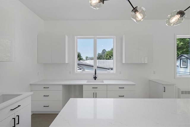 3 Forshee St, Monroe, NY 10950 - kitchen featuring modern cabinets, white cabinets, light stone countertops, and radiator