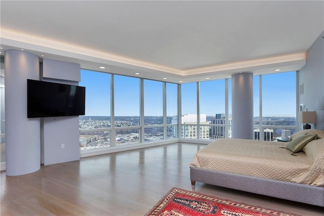 1 Renaissance Sq Unit Ph40A, White Plains, NY 10601 - bedroom with floor to ceiling windows, wood finished floors, a view of city, and recessed lighting