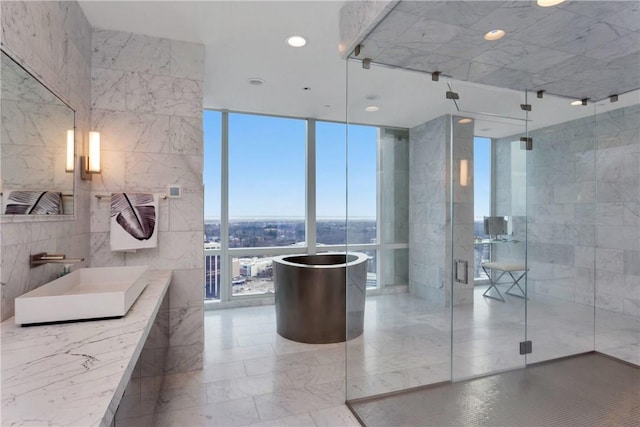 1 Renaissance Sq Unit Ph40A, White Plains, NY 10601 - full bathroom featuring expansive windows, tile walls, a freestanding bath, marble tiled floors, and a shower stall