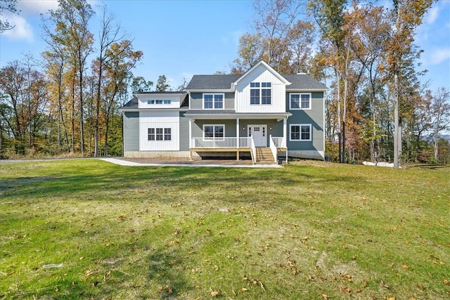 view of front of house with a porch and a front yard