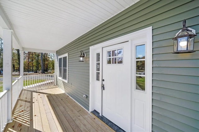 wooden terrace featuring covered porch