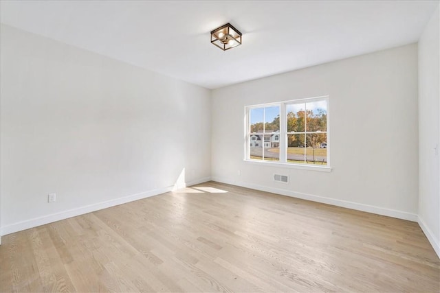 spare room featuring light hardwood / wood-style floors