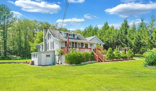 rear view of property with a yard