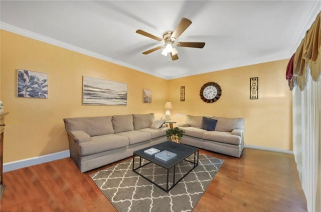 living room featuring ceiling fan, wood-type flooring, and ornamental molding