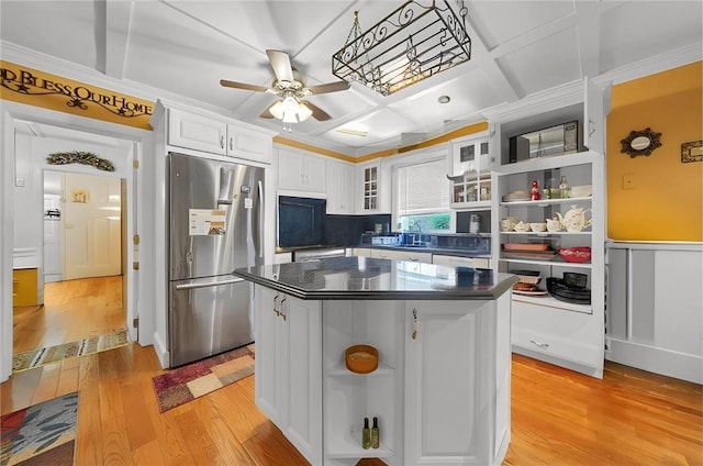 kitchen featuring a center island, coffered ceiling, light wood-type flooring, white cabinetry, and stainless steel refrigerator