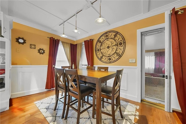 dining room featuring ornamental molding and light wood-type flooring