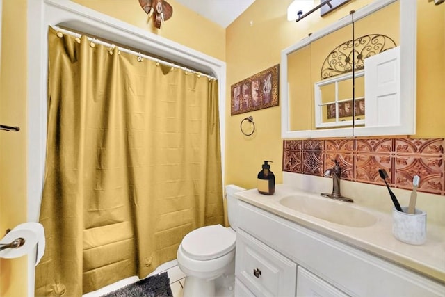 bathroom with toilet, vanity, backsplash, and tile patterned floors