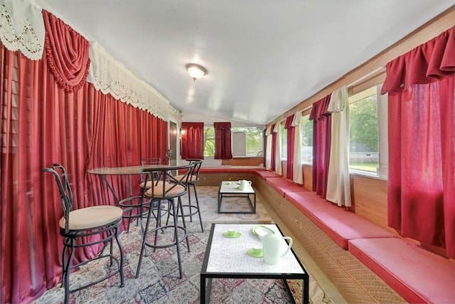 sunroom / solarium featuring vaulted ceiling