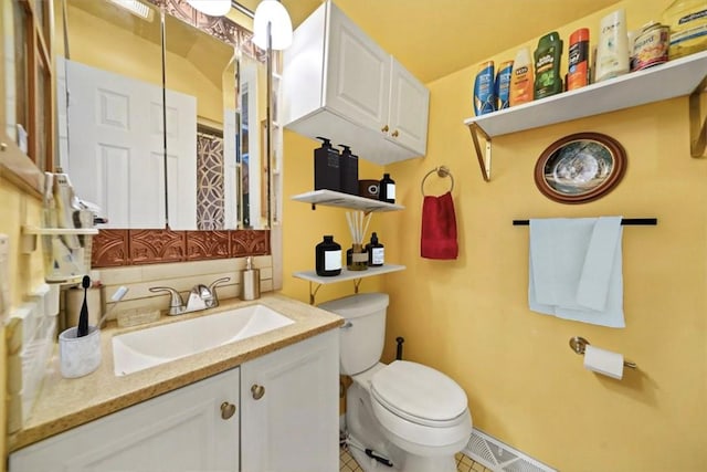 bathroom featuring toilet, vanity, and tile patterned floors