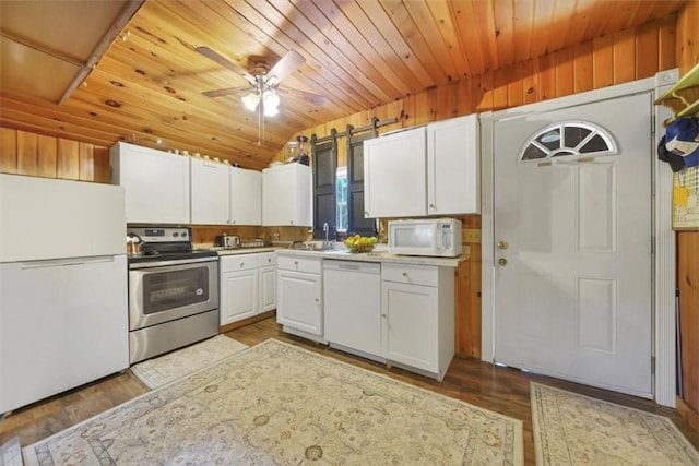 kitchen featuring white appliances, white cabinets, ceiling fan, wood-type flooring, and wood ceiling