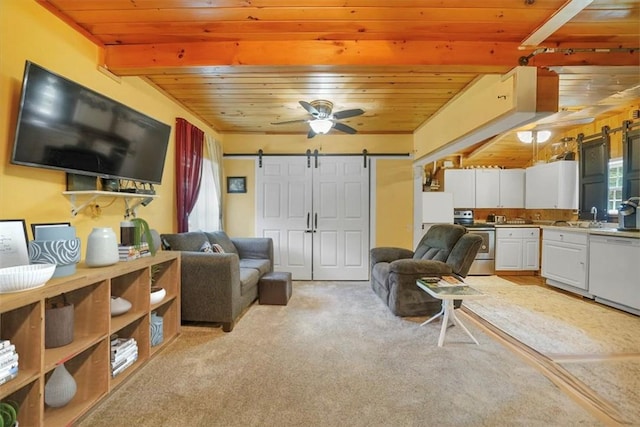 carpeted living room featuring wood ceiling, ceiling fan, sink, beam ceiling, and a barn door