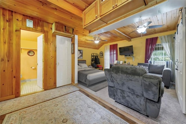 carpeted living room featuring ceiling fan, wooden ceiling, and wood walls