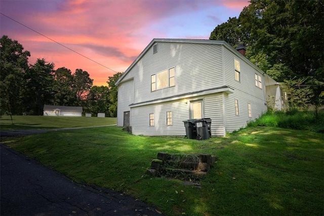 back house at dusk with a yard