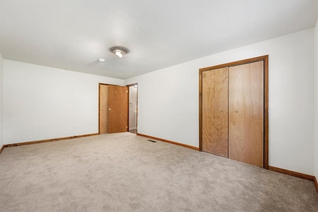 unfurnished bedroom with carpet floors and a closet