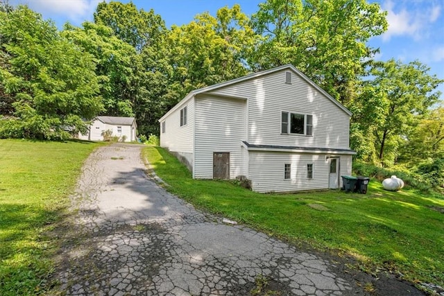 rear view of property with a yard