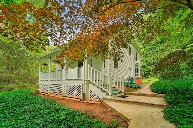 view of side of home with covered porch