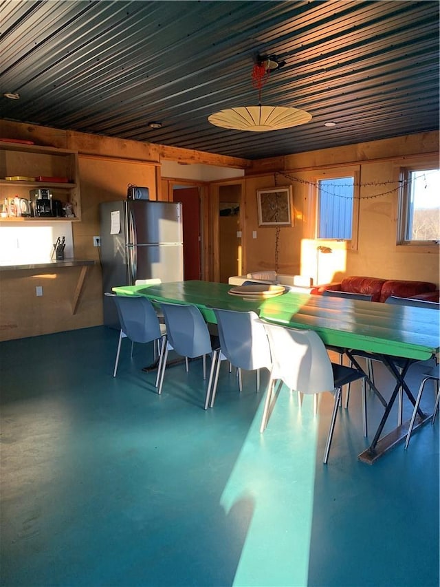 unfurnished dining area featuring concrete flooring