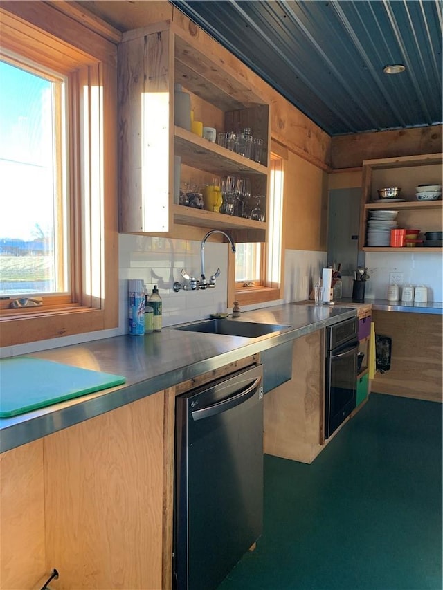 kitchen with dishwasher, sink, a wealth of natural light, and black oven