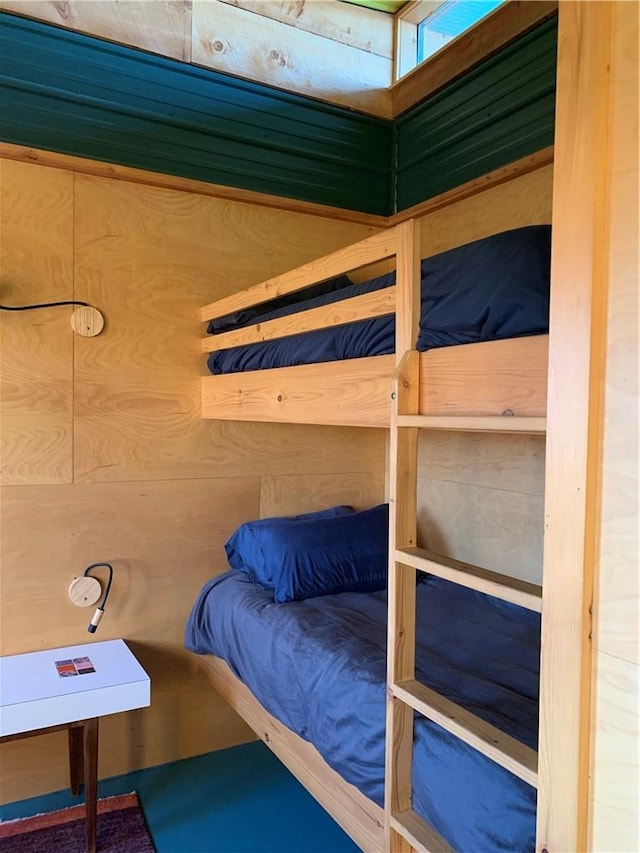 bedroom featuring wood walls