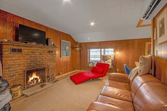 carpeted living room featuring a fireplace, lofted ceiling, and wood walls