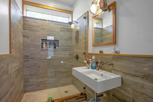 bathroom with a tile shower and sink