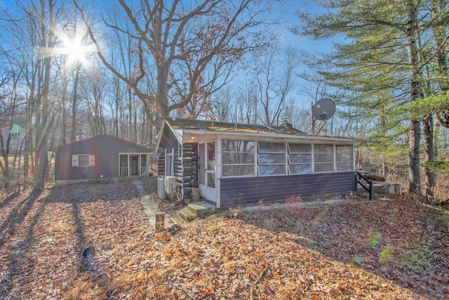 single story home featuring a sunroom