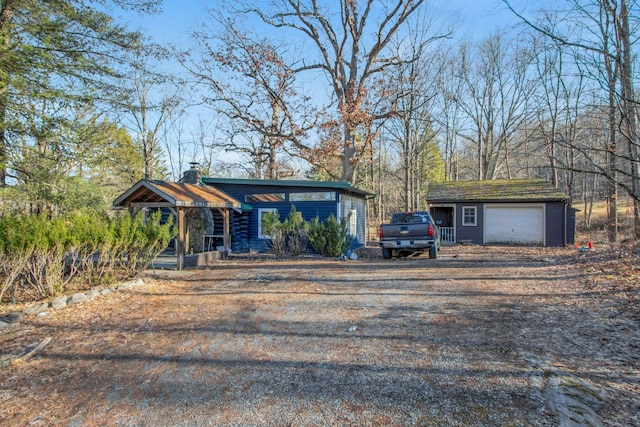 view of front of property with an outbuilding, a porch, and a garage