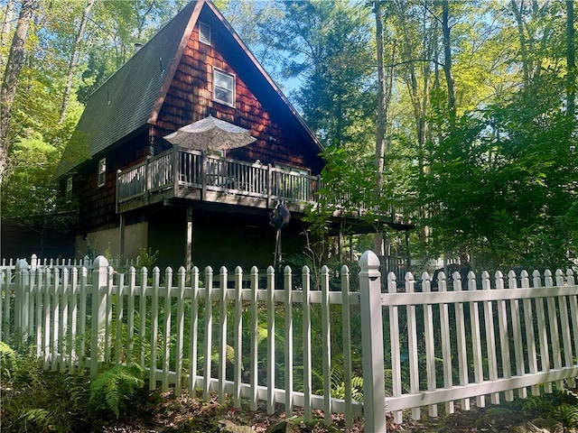 view of side of property featuring a wooden deck