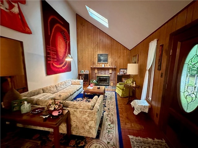 living room featuring a brick fireplace, wooden walls, and lofted ceiling with skylight