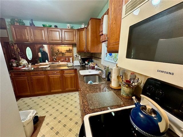 kitchen with black electric range oven and sink