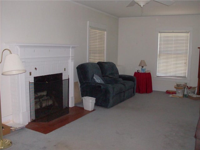 carpeted living room with ceiling fan