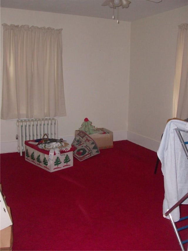 bedroom with ceiling fan, carpet floors, and radiator