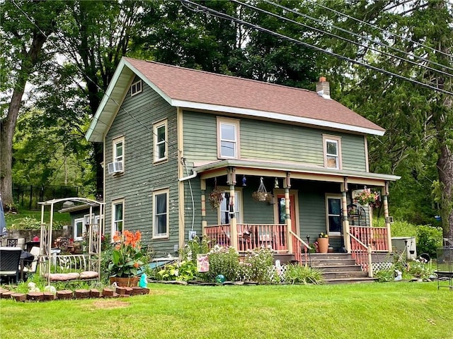 view of front of home featuring cooling unit, covered porch, and a front lawn