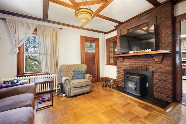 living room with a wood stove, crown molding, radiator, and light parquet flooring