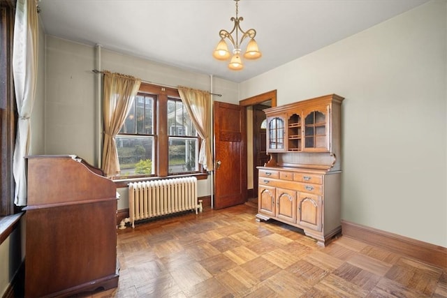 interior space featuring radiator, light parquet floors, and a notable chandelier