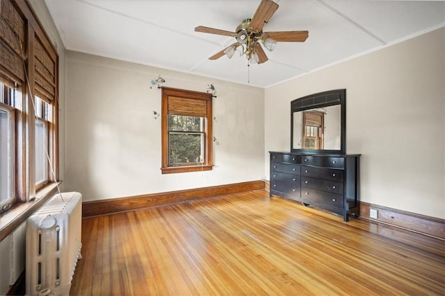 interior space featuring hardwood / wood-style floors, radiator, and ceiling fan