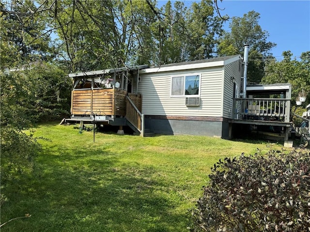 rear view of house with a yard, cooling unit, and a wooden deck