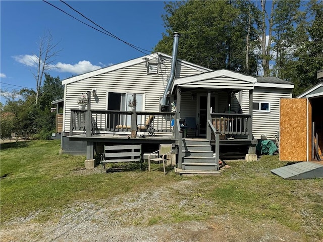 back of property with a wooden deck and a yard