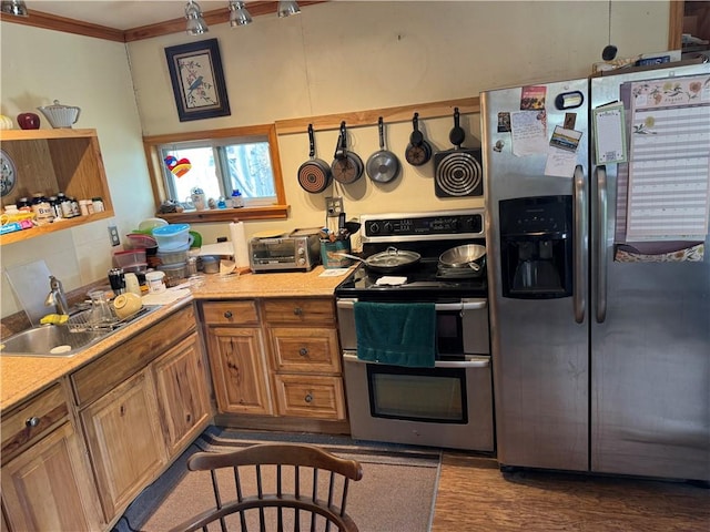 kitchen featuring hardwood / wood-style floors, sink, ornamental molding, and appliances with stainless steel finishes