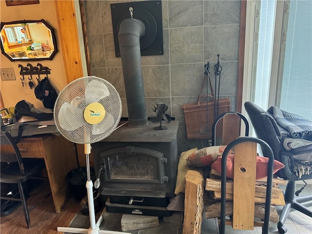 room details featuring hardwood / wood-style floors and a wood stove