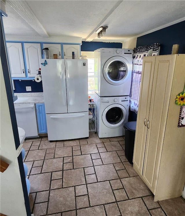 washroom with a textured ceiling and stacked washer and clothes dryer