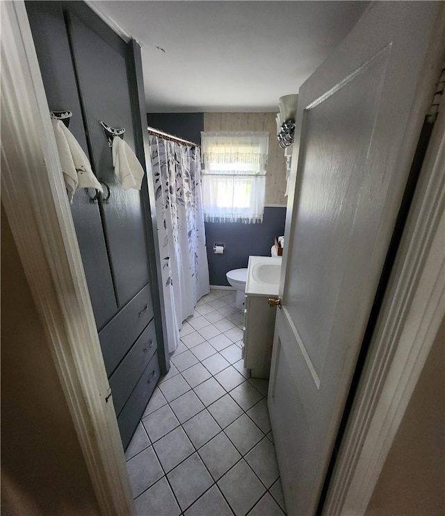 bathroom with tile patterned floors, vanity, toilet, and a shower with curtain